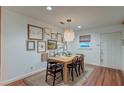 Cozy dining room features a wooden table, unique light fixture and gallery wall at 1706 W Avalon Cir, Charleston, SC 29407