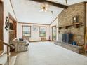Spacious living room with brick fireplace, large windows, and wood trim accents at 1876 Chilhowee Dr, Johns Island, SC 29455