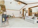 Cozy living room featuring exposed beams, brick fireplace, and staircase with railing detail at 1876 Chilhowee Dr, Johns Island, SC 29455