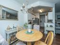 Charming dining area featuring a chandelier and a view of the adjacent kitchen at 1928 Chatelain Way, Mount Pleasant, SC 29464