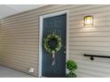 Charming front door with a decorative wreath and stylish outdoor lighting at 2011 N Highway 17 # 1100I, Mount Pleasant, SC 29466