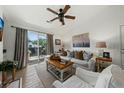 Bright living room with sliding glass doors, ceiling fan and modern decor at 2011 N Highway 17 # 1100I, Mount Pleasant, SC 29466