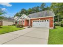 Attractive brick home with a well-kept lawn, a wide driveway, and an attached two-car garage at 215 Angora Way, Summerville, SC 29485