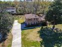 An aerial shot of a brick home with a long driveway and mature trees at 2467 Birkenhead Dr, Charleston, SC 29414