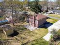 Backyard aerial view showcasing a brick home, patio, and storage shed at 2467 Birkenhead Dr, Charleston, SC 29414