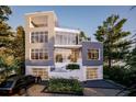 Striking modern home featuring large windows, clean lines, and a two-car garage at 304 Carolina Blvd, Isle of Palms, SC 29451