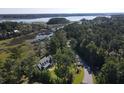 Aerial view of a charming home by the marsh, showcasing its unique coastal setting and waterfront access at 4086 Lady Banks Ln, Ravenel, SC 29470
