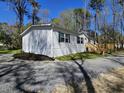 Single story home with fresh landscaping, a gravel driveway, and newly constructed front porch at 4532 S Carolina # 41, Huger, SC 29450