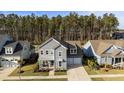 Aerial view of a gray two story home with manicured lawn and two-car garage at 460 Cool Bend Ln, Summerville, SC 29486