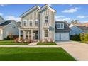 Charming two-story home with gray siding, a well manicured lawn, and a two-car garage at 460 Cool Bend Ln, Summerville, SC 29486
