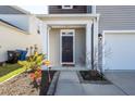 Charming entryway featuring a dark door, white pillars, and a landscaped flower bed at 4809 Bushel Rd, Ladson, SC 29456