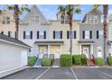 Charming townhouses with palm trees, well-maintained landscaping, and ample parking space in a well-kept community at 4913 Lake Palmetto Ln, North Charleston, SC 29418