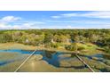 Beautiful aerial view showcasing a home with a private dock and serene waterfront at 5758 Chisolm Rd, Johns Island, SC 29455