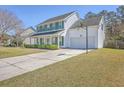 Two-story home with an attached garage and a basketball hoop at 628 Alwyn Blvd, Summerville, SC 29485