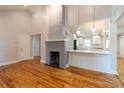 Open-concept living area features a painted brick fireplace and a seamless transition to a modern, well-lit kitchen at 708 S Laurel St, Summerville, SC 29483
