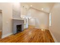Spacious living area boasts vaulted ceilings and a painted brick fireplace, enhanced by gleaming hardwood floors and natural light at 708 S Laurel St, Summerville, SC 29483