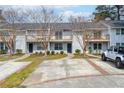 White townhomes in a community with well-manicured lawns and ample parking at 7814 Nummie Ct, North Charleston, SC 29418