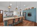 Bright kitchen featuring custom blue cabinets, a butcher block island, and stainless steel appliances at 10044 Randall Rd, McClellanville, SC 29458