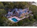 Expansive waterfront estate features a private pool, outdoor deck space, and lush landscaping, creating an idyllic coastal retreat at 108 Salthouse Ln, Kiawah Island, SC 29455