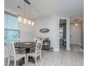 Bright dining area with a modern light fixture, round table, and stylish decor, perfect for gatherings at 1081 Magnolia Warbler Way, Ravenel, SC 29470