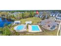 Aerial view of a community pool, splashpad, playground, and lakefront amenity center at 122 Yorkshire Dr, Moncks Corner, SC 29461