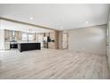 Spacious open-concept living and kitchen area featuring modern light wood floors and ample natural light at 1360 Burr Hill Rd, Cottageville, SC 29435
