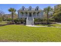 Beautiful home with a classic design, boasting a spacious porch and vibrant green lawn at 1367 N Edgewater Dr, Charleston, SC 29407