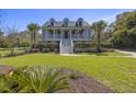 Inviting two-story home with lush landscaping, showcasing curb appeal and a serene setting at 1367 N Edgewater Dr, Charleston, SC 29407