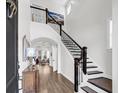 Elegant foyer with high ceilings, a beautiful staircase, and hardwood floors at 1391 Crane Creek Dr, Mount Pleasant, SC 29466