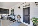 Inviting front porch featuring comfortable seating, a cozy fire pit and a stylish front door at 1391 Crane Creek Dr, Mount Pleasant, SC 29466