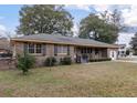 Classic single-story brick home featuring a well-maintained lawn and traditional architectural details at 1404 Ivy Isle Dr, Charleston, SC 29412