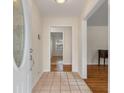 Inviting home foyer featuring tile flooring and views into the living spaces with hardwood floors at 1404 Ivy Isle Dr, Charleston, SC 29412