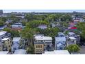 This aerial showcases the house nestled among lush trees in a vibrant neighborhood, near the city at 15 Corinne St # B, Charleston, SC 29403