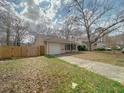 Charming single-story home with a front yard, driveway, and attached garage under a cloudy sky at 154 Tabby Creek Cir, Summerville, SC 29486