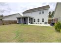 Spacious backyard featuring a large, well-maintained lawn and screened-in porch at 1540 Dawn Mist Way, Charleston, SC 29414