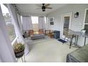 Inviting screened porch with a ceiling fan and comfortable seating area at 1540 Dawn Mist Way, Charleston, SC 29414
