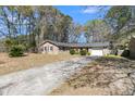 Inviting brick home boasts a lush front yard and attached garage, perfect for suburban living at 185 Foxborough Rd, Goose Creek, SC 29445