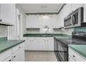 Bright kitchen with white cabinets, green countertops, modern appliances, and a garden window at 185 Foxborough Rd, Goose Creek, SC 29445