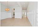 Bright, open-concept living room featuring hardwood floors and decorative lighting fixtures creating a warm ambiance at 190 Steepbrook, Summerville, SC 29486