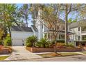 Light blue two-story home with a well-manicured lawn and brick retaining wall. Garage shown at 205 Fairchild St, Daniel Island, SC 29492
