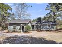 Charming one story home with mature landscaping, a brick chimney and a side entry at 212 Lake Moultrie Dr, Bonneau, SC 29431