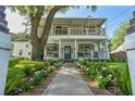 Inviting two-story home with a well-manicured lawn and colorful flowerbeds leading to the front door at 2142 Golfview Dr, Charleston, SC 29412