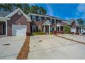 Desirable brick townhouses with convenient driveway parking and manicured shrubbery at 219 Tuscany Ct, Ladson, SC 29456