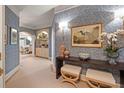 Chic hallway with arched doorways, built-in shelving, designer wallpaper, and stylish decor at 233 S Plaza Ct # 210, Mount Pleasant, SC 29464