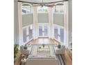 Open living room with high ceilings, natural light and hardwood floors at 24 Waterway Island Dr, Isle of Palms, SC 29451