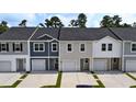 The townhomes feature a modern design with individual garages and well-maintained driveways and landscaping at 2404 Scarlett Maple St, Summerville, SC 29486