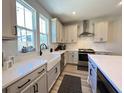 Modern kitchen with white cabinets, quartz countertops, and stainless steel appliances at 251 Summers Dr, Summerville, SC 29485