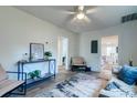 Bright living room featuring hardwood floors, fresh paint, ceiling fan, and stylish decor at 2604 Ferrara Dr, North Charleston, SC 29405