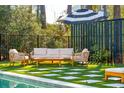 Outdoor entertaining area featuring plush seating, an umbrella and artificial turf at 307 Shoals Dr, Mount Pleasant, SC 29464