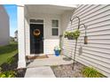 Inviting front porch with a decorative wreath, potted plants, and a welcome sign, exuding curb appeal at 315 Black Birch Dr, Summerville, SC 29486